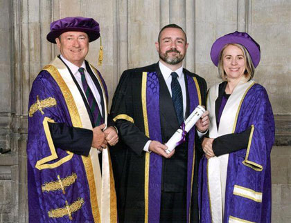 Kevin receives his honorary fellowship from Chancellor Alan Titchmarsh with Vice-Chancellor Professor Joy Carter